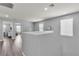 Upstairs hallway with wood-look floors and natural light streaming from a window at 2116 Via Firenze, Henderson, NV 89044