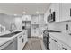 Modern kitchen with stainless steel appliances, white cabinets, and a functional layout at 2116 Via Firenze, Henderson, NV 89044