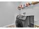 Dedicated laundry area with modern appliances and shelving for storage and organization at 2116 Via Firenze, Henderson, NV 89044