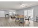 Open-concept living space with dining area, comfortable seating, and access to the outdoor patio at 2116 Via Firenze, Henderson, NV 89044