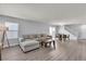 Spacious living room with grey walls, wood flooring, and modern furnishings offers a comfortable gathering space at 2116 Via Firenze, Henderson, NV 89044
