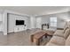 Spacious living area with a large TV and modern sofa, creating a perfect entertainment space at 2116 Via Firenze, Henderson, NV 89044