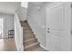Staircase featuring wood stairs and white railings, leading to the upper level at 2116 Via Firenze, Henderson, NV 89044