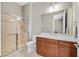 Bathroom featuring walk-in shower, single sink vanity, toilet and large mirror at 2132 Twin Falls Dr, Henderson, NV 89044