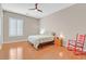 Comfortable bedroom with wood floors, ceiling fan, and natural light from the window at 2132 Twin Falls Dr, Henderson, NV 89044