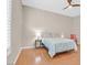 Cozy bedroom with a ceiling fan, plantation shutters, and wood flooring at 2132 Twin Falls Dr, Henderson, NV 89044