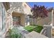 Inviting front entrance with beautiful double doors, artificial lawn, and attractive landscaping at 2132 Twin Falls Dr, Henderson, NV 89044