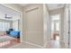 Hallway leading to main bedroom with ceiling fan, wood floors, and plantation shutters at 2132 Twin Falls Dr, Henderson, NV 89044