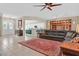 Spacious living room featuring a large leather sofa, stylish rug, and open layout at 2132 Twin Falls Dr, Henderson, NV 89044