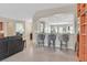 Open-concept living room features a bar, tile floors and views to the kitchen at 2132 Twin Falls Dr, Henderson, NV 89044