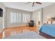 Inviting main bedroom with hardwood floors, shutters, and comfortable armchair at 2132 Twin Falls Dr, Henderson, NV 89044