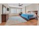 Spacious main bedroom with hardwood floors, ceiling fan, dresser and windows with plantation shutters at 2132 Twin Falls Dr, Henderson, NV 89044