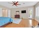 Bright main bedroom with wood floors, flat screen TV, ceiling fan, and access to outside deck at 2132 Twin Falls Dr, Henderson, NV 89044
