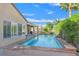 Inviting pool area offering a refreshing oasis with a stone trim and lush landscaping at 2132 Twin Falls Dr, Henderson, NV 89044