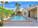 Inviting backyard pool with mature landscaping and tranquil water feature for relaxation at 2132 Twin Falls Dr, Henderson, NV 89044