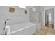Bright bathroom featuring a soaking tub, glass-enclosed shower, and patterned tile flooring at 240 Windsong Dr, Henderson, NV 89074
