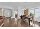 Inviting dining area with hardwood floors, a modern chandelier, and lots of natural light at 240 Windsong Dr, Henderson, NV 89074
