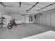 Spacious garage features storage cabinets, epoxy floors, and a bicycle at 240 Windsong Dr, Henderson, NV 89074