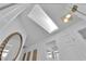 Hallway showcasing skylight, white walls, and decorative wall art at 240 Windsong Dr, Henderson, NV 89074