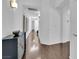 Hallway featuring hardwood floors, stylish console, and multiple entryways at 240 Windsong Dr, Henderson, NV 89074