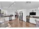 Open eat-in kitchen with stainless steel appliances, granite counters, and hardwood floors at 240 Windsong Dr, Henderson, NV 89074