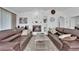 Cozy living room showcases a centered fireplace, custom built-ins, and matching leather sofas at 240 Windsong Dr, Henderson, NV 89074