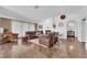 Spacious living room with an open layout, a fireplace, hardwood flooring, and large windows at 240 Windsong Dr, Henderson, NV 89074