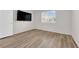 Bedroom with new wood-look laminate flooring and view of mounted TV at 2514 Tropical Sands Ave, North Las Vegas, NV 89031