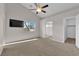 Spacious primary bedroom with vaulted ceilings, ceiling fan, large window and adjacent bathroom at 2514 Tropical Sands Ave, North Las Vegas, NV 89031