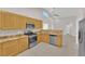 Kitchen with stainless steel appliances, granite countertops, light wood cabinetry, and tile flooring at 2514 Tropical Sands Ave, North Las Vegas, NV 89031