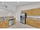 Spacious kitchen with stainless steel appliances, granite countertops, tile flooring, and ample storage space at 2514 Tropical Sands Ave, North Las Vegas, NV 89031