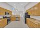 Well-lit kitchen with tile flooring, light wood cabinetry, stainless steel appliances, and granite countertops at 2514 Tropical Sands Ave, North Las Vegas, NV 89031