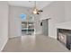Well-lit living room with tile floors, a fireplace, sliding glass doors leading to the backyard, and a barn door at 2514 Tropical Sands Ave, North Las Vegas, NV 89031