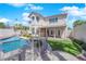Backyard featuring a pool, artificial turf, covered patio, mature trees, and rock features at 2595 Aviv Ct, Las Vegas, NV 89121
