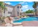 A gorgeous backyard featuring a pool, spa, patio, and lush landscaping at 2595 Aviv Ct, Las Vegas, NV 89121