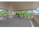 The large covered balcony has views of trees, blue skies, and a white railing at 2595 Aviv Ct, Las Vegas, NV 89121