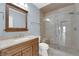 Stylish bathroom featuring a walk-in shower with glass doors and a vanity with a framed mirror at 2595 Aviv Ct, Las Vegas, NV 89121