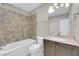 Bathroom features tiled shower-tub combination, vanity with countertop, and a neutral palette at 2595 Aviv Ct, Las Vegas, NV 89121