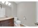 Half bathroom with brown vanity, neutral walls, and a white toilet at 2595 Aviv Ct, Las Vegas, NV 89121