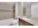 Updated bathroom features a shower-tub combo, stone backsplash, and single vanity with ample countertop space at 2595 Aviv Ct, Las Vegas, NV 89121