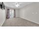 Spacious bedroom with a ceiling fan, carpet, and french doors leading to the backyard at 2595 Aviv Ct, Las Vegas, NV 89121