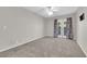 This bedroom includes neutral carpet, ceiling fan, and access to the balcony at 2595 Aviv Ct, Las Vegas, NV 89121