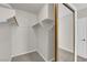 The walk-in closet has neutral carpet, shelving, and metal clothes rods at 2595 Aviv Ct, Las Vegas, NV 89121