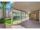 Spacious covered patio with brick flooring and a backyard view including artificial turf, pool, and sauna at 2595 Aviv Ct, Las Vegas, NV 89121