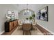 Bright dining room with modern decor, statement art, and seating for eight at 2595 Aviv Ct, Las Vegas, NV 89121