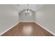 Bright formal dining room featuring a chandelier, hardwood floors, and large window at 2595 Aviv Ct, Las Vegas, NV 89121
