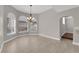 Dining room featuring a chandelier, large windows, tile floors, and neutral paint at 2595 Aviv Ct, Las Vegas, NV 89121