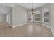 Bright dining room featuring wood-look floors, large windows and elegant chandelier at 2595 Aviv Ct, Las Vegas, NV 89121
