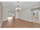 Open dining room featuring a chandelier, hardwood floors, and views into other rooms at 2595 Aviv Ct, Las Vegas, NV 89121