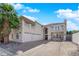 Stucco home featuring a three-car garage, balcony, red tile roof, and mature palm tree at 2595 Aviv Ct, Las Vegas, NV 89121